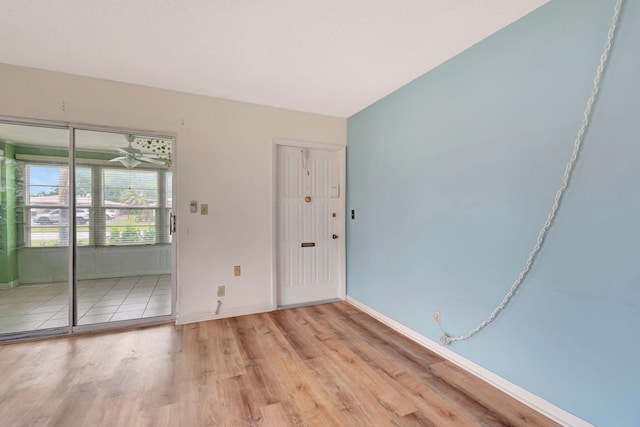 empty room featuring ceiling fan and light hardwood / wood-style floors