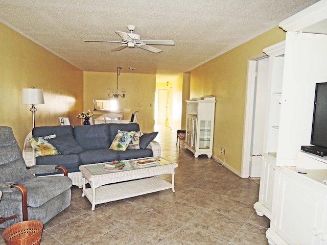 living room with tile floors and ceiling fan with notable chandelier