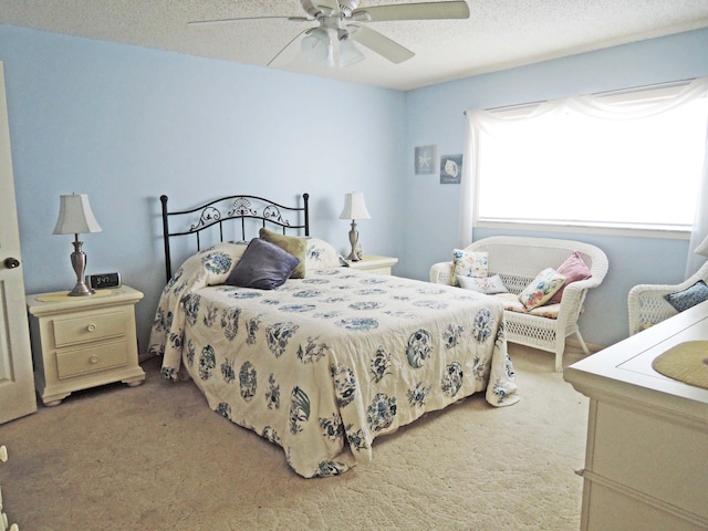 bedroom with light carpet, a textured ceiling, and ceiling fan