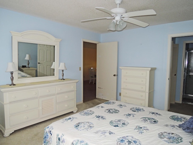 carpeted bedroom with a textured ceiling and ceiling fan