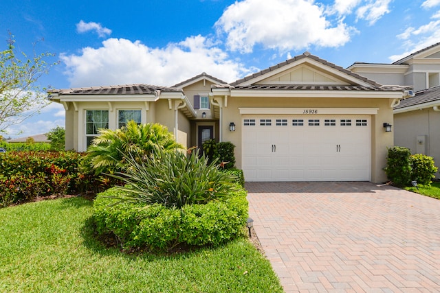 view of front of house with a front lawn and a garage