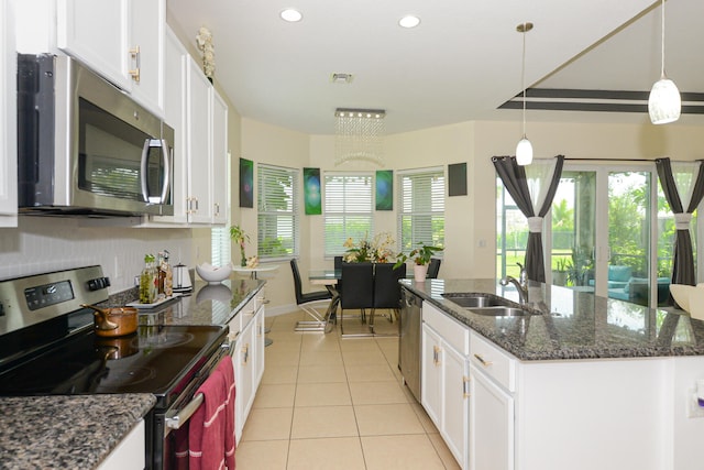 kitchen featuring appliances with stainless steel finishes, white cabinetry, sink, and pendant lighting