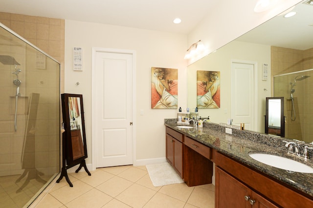 bathroom with oversized vanity, an enclosed shower, tile floors, and dual sinks