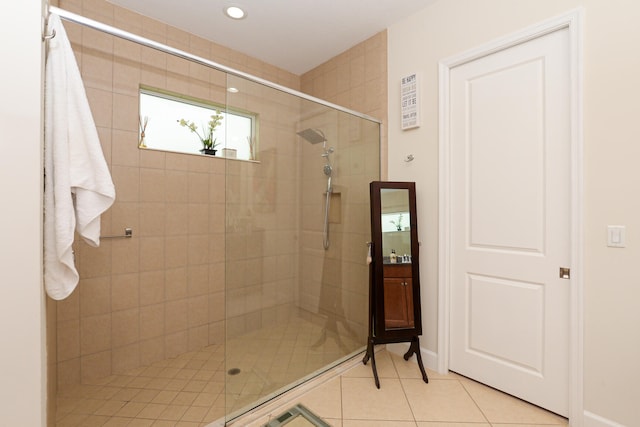 bathroom featuring an enclosed shower, vanity, and tile flooring