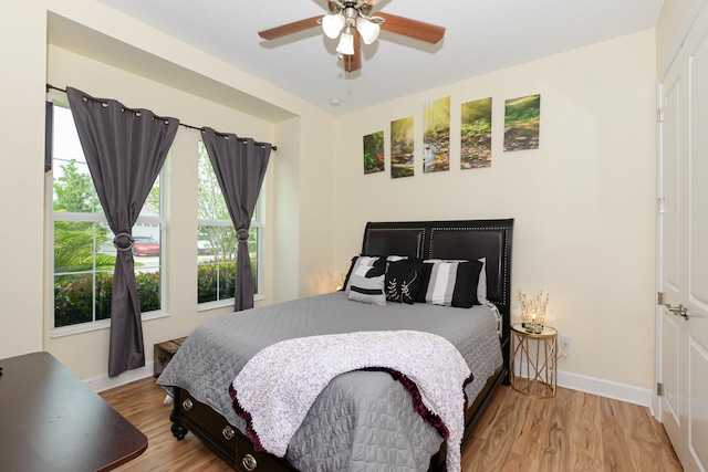 bedroom with light hardwood / wood-style floors and ceiling fan