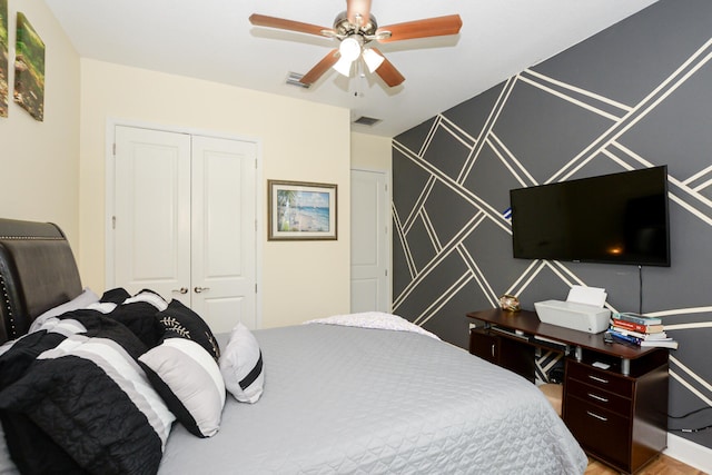 bedroom featuring a closet, ceiling fan, and hardwood / wood-style flooring