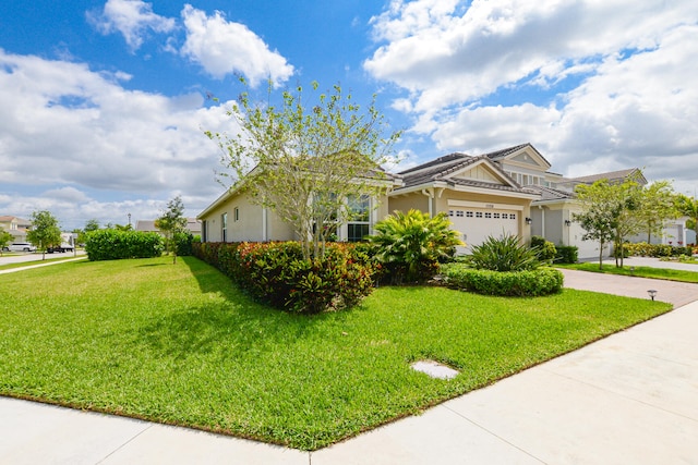 view of front of home with a front lawn and a garage