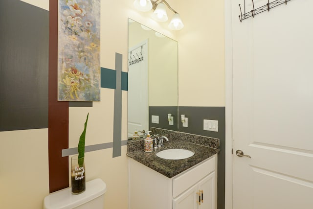 bathroom featuring toilet and vanity