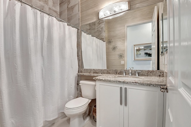 bathroom featuring oversized vanity, toilet, and tile flooring