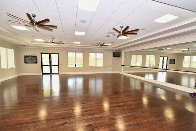 spare room with a raised ceiling, dark hardwood / wood-style floors, and ceiling fan