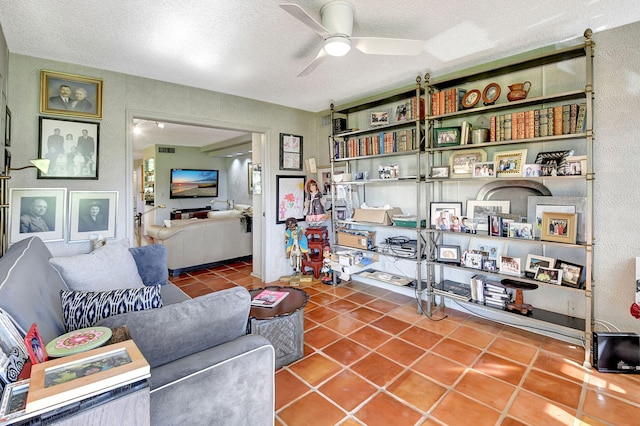 interior space with tile patterned flooring, a textured ceiling, and ceiling fan