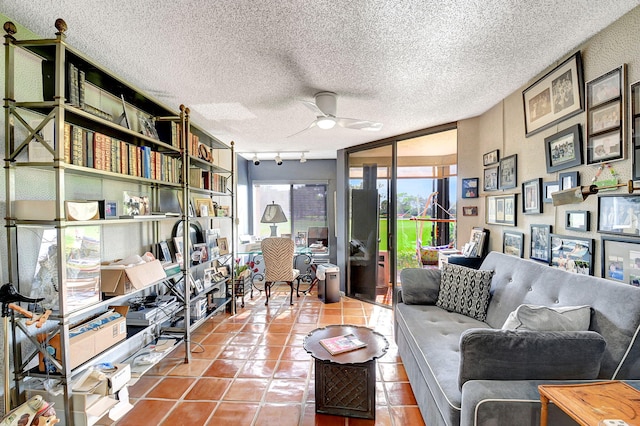 interior space featuring a textured ceiling, rail lighting, and ceiling fan