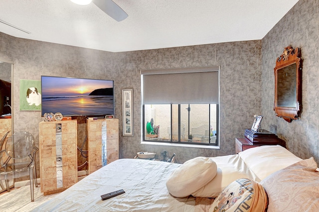 bedroom with a textured ceiling and ceiling fan