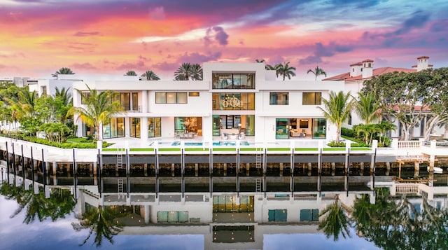 outdoor building at dusk featuring a pool