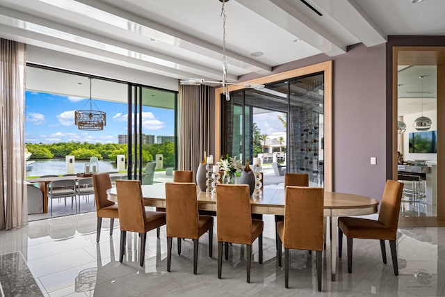 dining area with a wealth of natural light and a water view