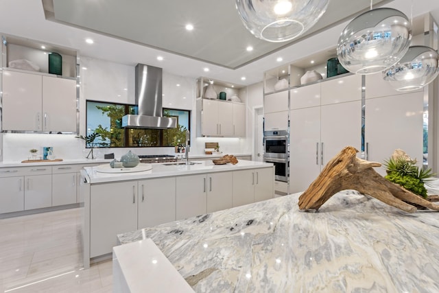 kitchen with modern cabinets, white cabinets, and island range hood