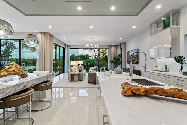 interior space with recessed lighting, white cabinets, and a sink