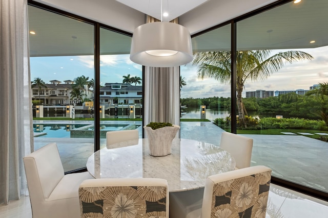 dining area with plenty of natural light and a water view