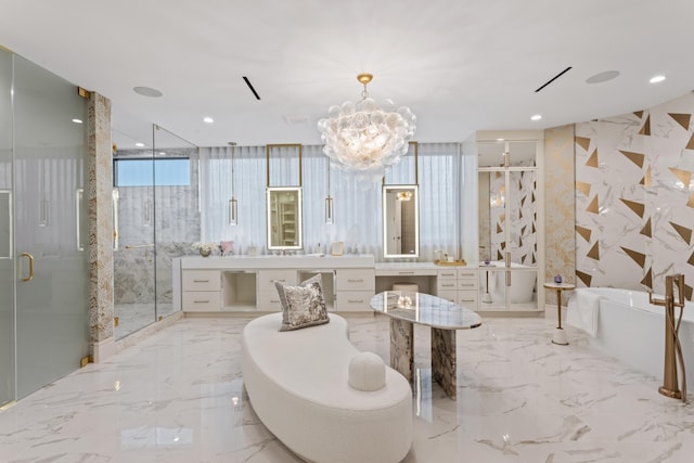 bathroom featuring marble finish floor, recessed lighting, a shower stall, a freestanding bath, and stone wall