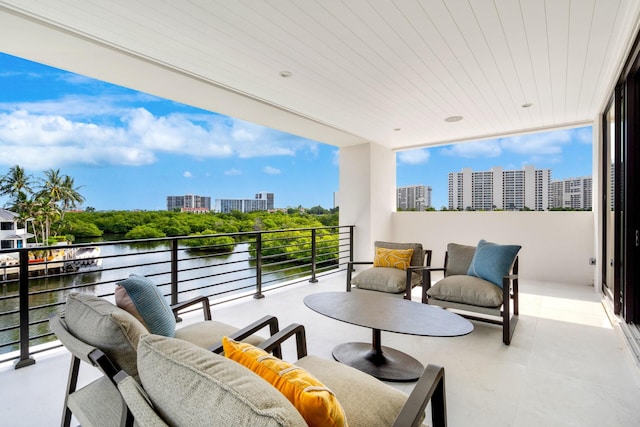 balcony with a water view and a city view