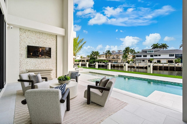 outdoor pool featuring a patio, a residential view, a water view, and an outdoor living space