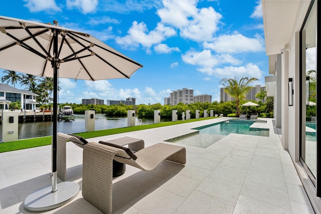 pool featuring a view of city, a patio area, and a water view