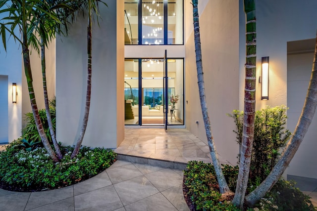 entrance to property featuring stucco siding