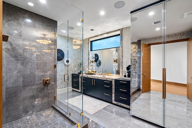 bathroom featuring tile walls, walk in shower, and vanity