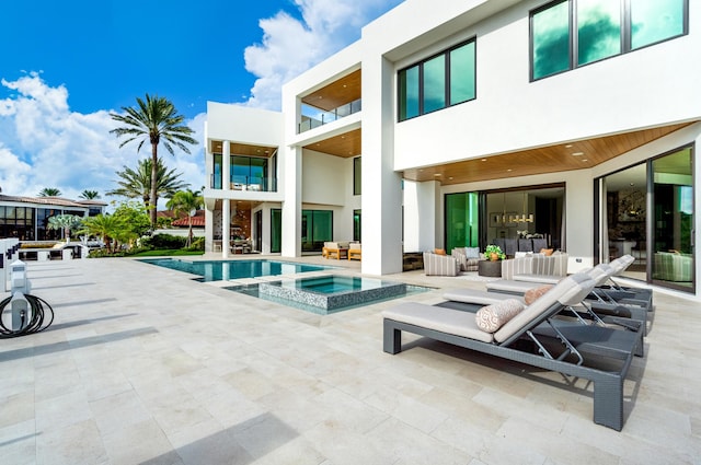 view of swimming pool with an outdoor living space, an in ground hot tub, and a patio