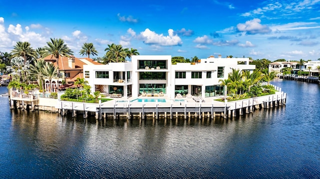 dock area featuring a water view and a pool