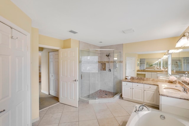 bathroom with independent shower and bath, tile flooring, and vanity