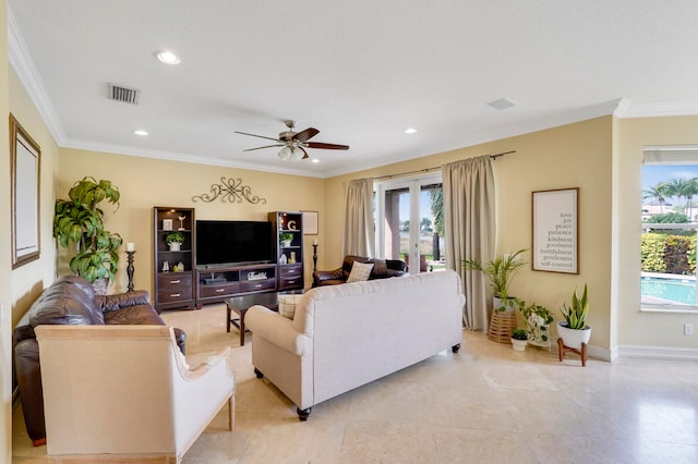 living room with a wealth of natural light, crown molding, and ceiling fan