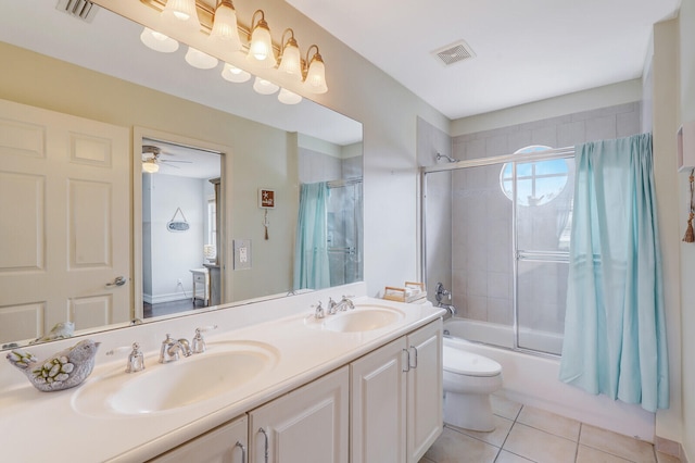 full bathroom with tile flooring, ceiling fan, dual vanity, toilet, and shower / bath combination with glass door