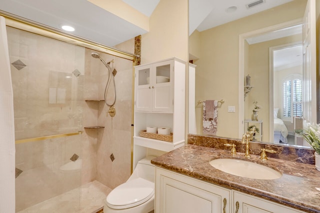 bathroom featuring an enclosed shower, vanity, and toilet