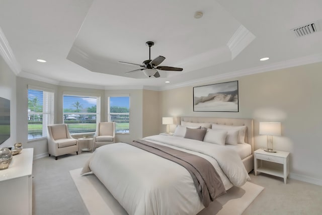 carpeted bedroom with ceiling fan, crown molding, and a raised ceiling