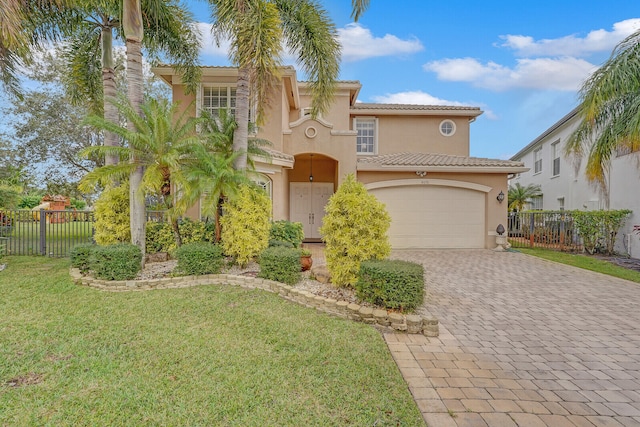 mediterranean / spanish-style home featuring a garage and a front lawn