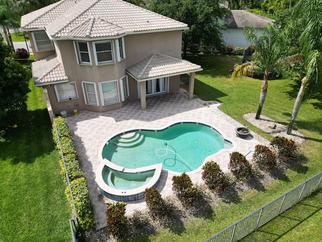 view of swimming pool featuring a patio area, an in ground hot tub, and a lawn