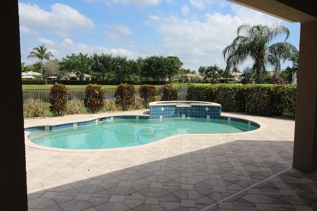 view of pool featuring a patio area and an in ground hot tub