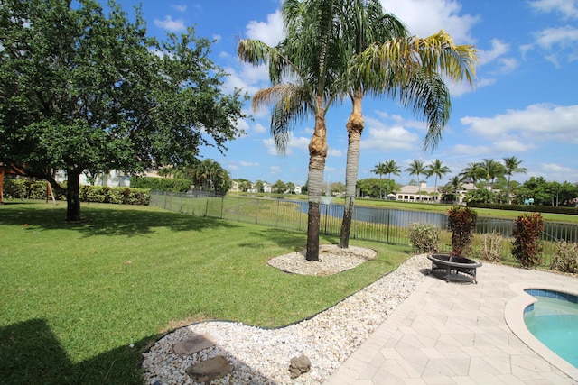 view of yard featuring a fenced in pool, an outdoor fire pit, and a patio