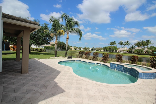 view of swimming pool featuring a patio area and an in ground hot tub