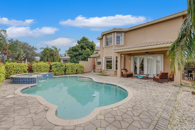 view of pool with a patio, french doors, ceiling fan, and an in ground hot tub