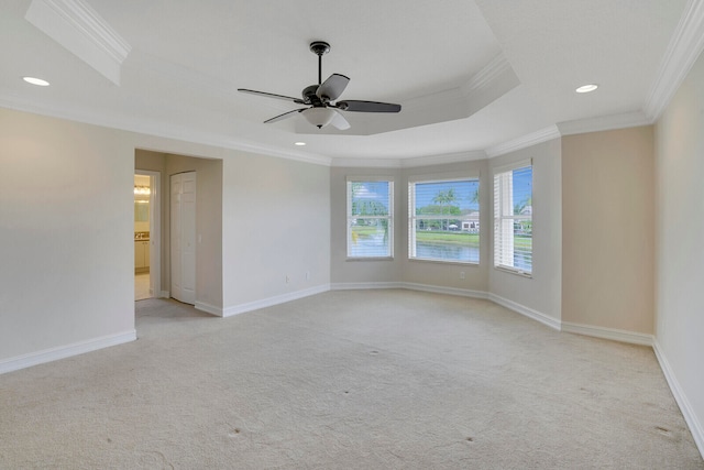 carpeted spare room with ceiling fan and crown molding