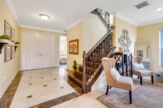 entrance foyer with crown molding and light tile floors