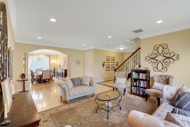 living room with tile flooring, an inviting chandelier, and ornamental molding