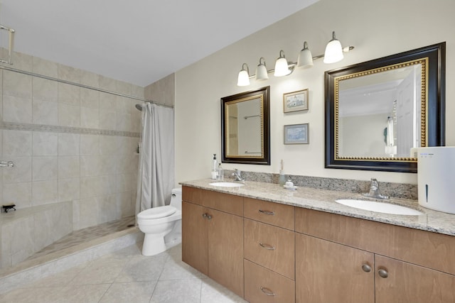 bathroom featuring toilet, dual sinks, vanity with extensive cabinet space, and tile flooring