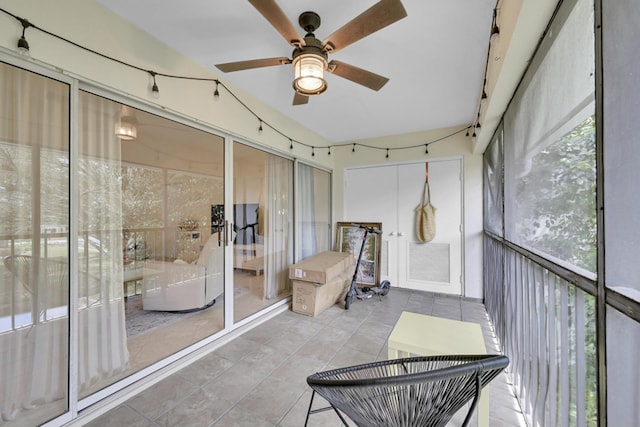 sunroom / solarium featuring ceiling fan