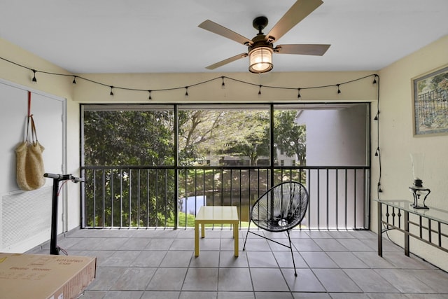 sunroom / solarium featuring ceiling fan and a wealth of natural light