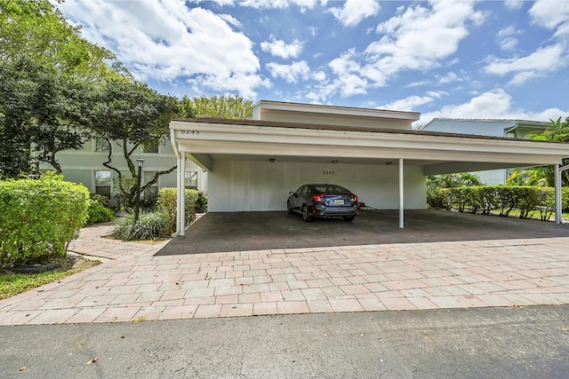 view of vehicle parking with a carport