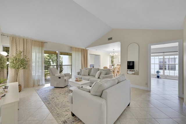 tiled living room with high vaulted ceiling and an inviting chandelier