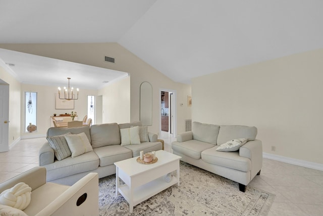 tiled living room with a notable chandelier and vaulted ceiling